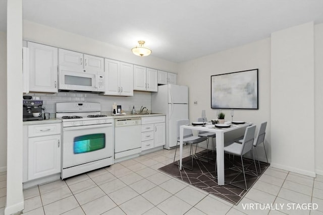 280 Boylston St Unit 110, Newton, MA 02467 - kitchen with white appliances, light countertops, white cabinetry, tasteful backsplash, and light tile patterned flooring