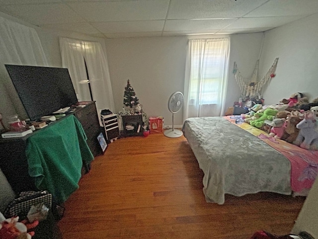 bedroom featuring a paneled ceiling and hardwood / wood-style flooring