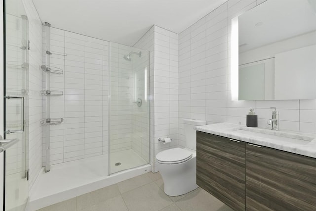 bathroom featuring tile walls, tasteful backsplash, toilet, a shower stall, and tile patterned floors