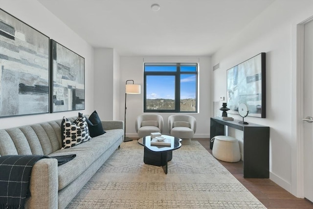 living area featuring baseboards and wood finished floors