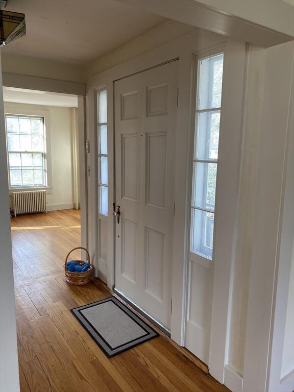 entryway with radiator and light wood-type flooring