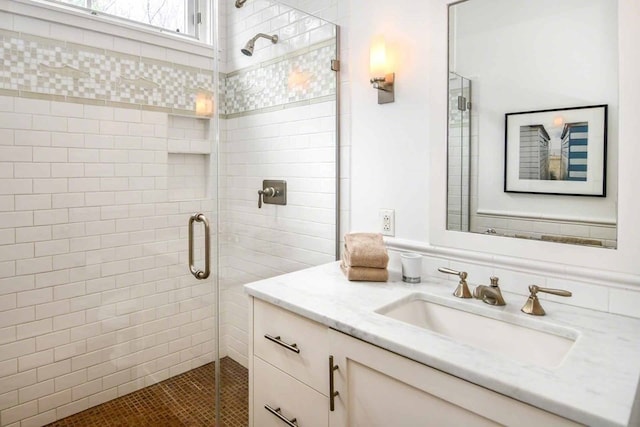 bathroom with walk in shower and vanity