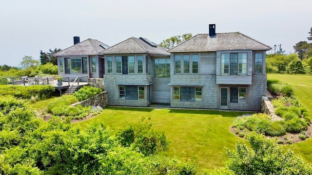 rear view of property with a lawn