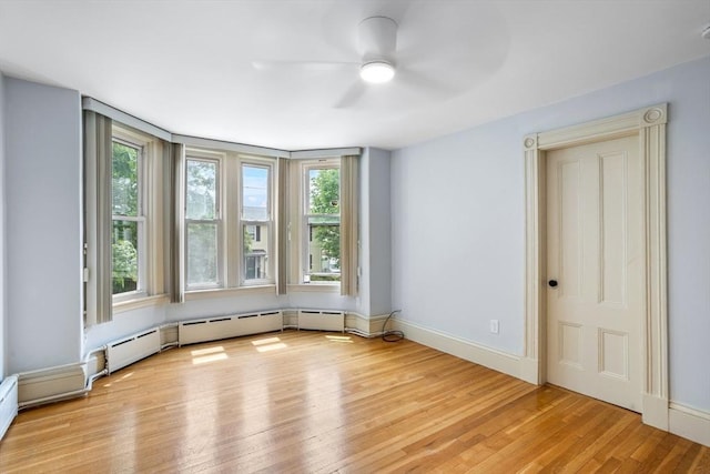 14 Horace St Unit 2, Boston, MA 02128 - empty room with light wood-style floors, a ceiling fan, baseboard heating, and baseboards