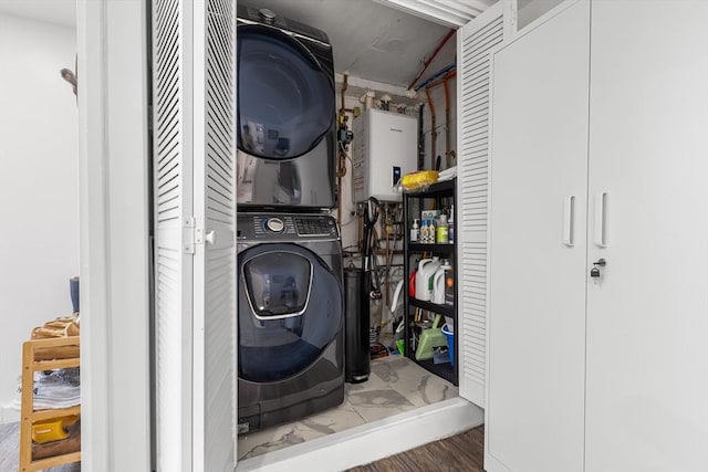138 Dartmouth St, Everett, MA 02149 - laundry area with stacked washing machine and dryer, tankless water heater, and wood finished floors