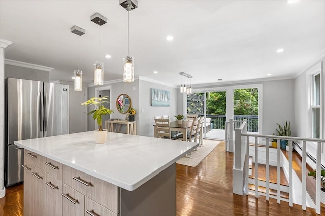 138 Dartmouth St, Everett, MA 02149 - kitchen featuring freestanding refrigerator, ornamental molding, dark wood-type flooring, a center island, and light countertops