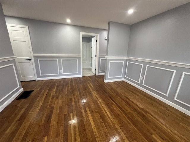 unfurnished room featuring dark wood-type flooring