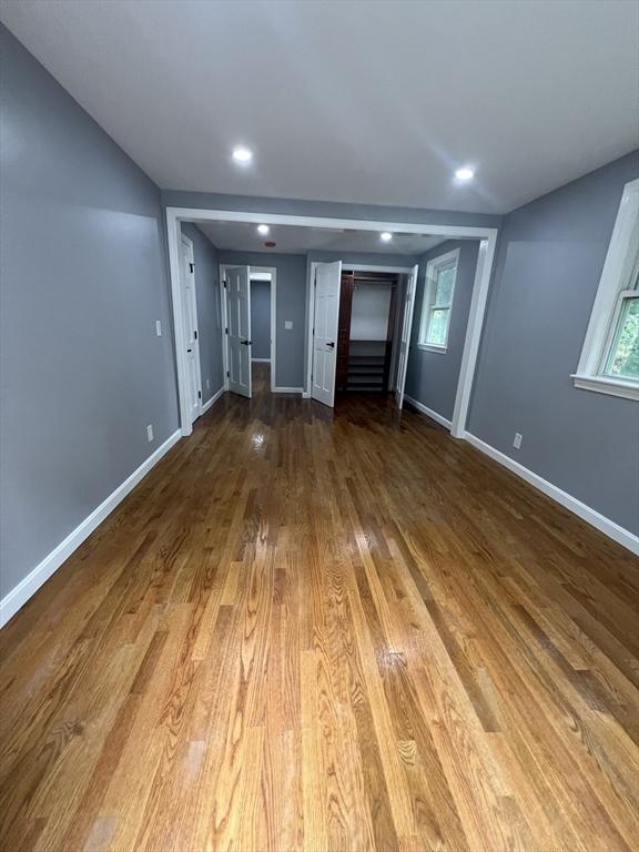 unfurnished living room with hardwood / wood-style flooring and plenty of natural light