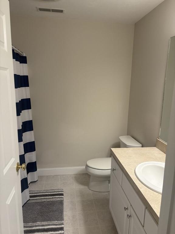 43 Longview Cir Unit B, Ayer, MA 01432 - bathroom featuring vanity, toilet, baseboards, tile patterned flooring, and curtained shower