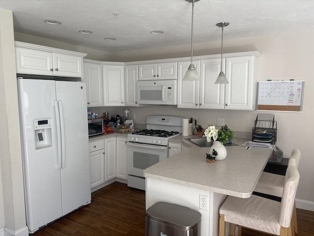 43 Longview Cir Unit B, Ayer, MA 01432 - kitchen featuring white appliances, a peninsula, white cabinets, dark wood-style floors, and recessed lighting