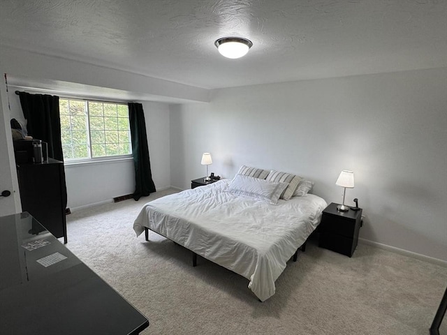 159 Tall Oaks Dr Unit H, Weymouth, MA 02190 - bedroom with light carpet, baseboards, and a textured ceiling