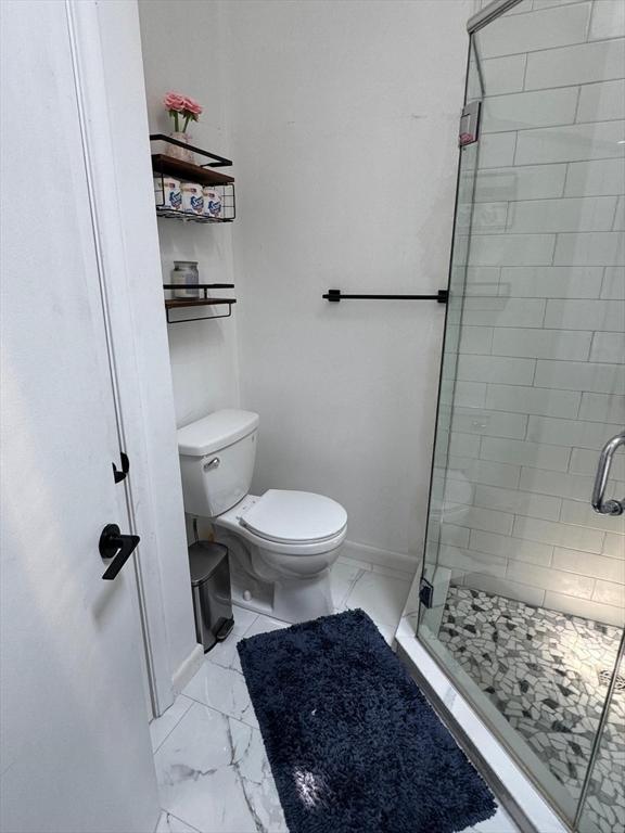 159 Tall Oaks Dr Unit H, Weymouth, MA 02190 - full bathroom featuring a stall shower, marble look tiles, and toilet