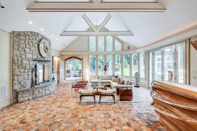 70 Lazell St, Hingham, MA 02043 - living room with high vaulted ceiling, stone finish flooring, and a stone fireplace