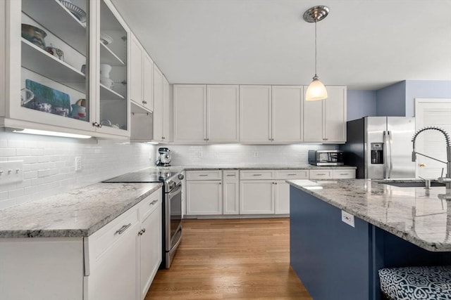 4 Old Meadow Ln, Harvard, MA 01451 - kitchen with decorative backsplash, white cabinets, decorative light fixtures, and stainless steel appliances