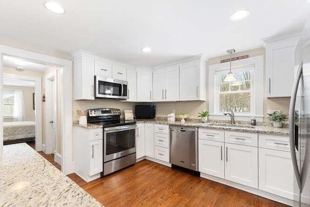 kitchen with sink, white cabinetry, and stainless steel appliances