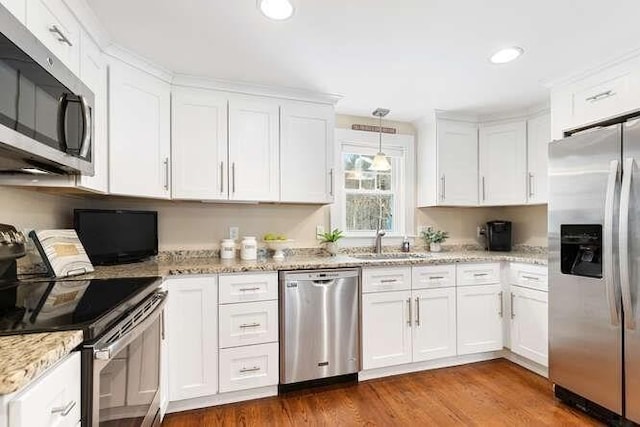 kitchen featuring white cabinets, stainless steel appliances, and sink