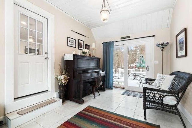 living area featuring light tile patterned floors and lofted ceiling