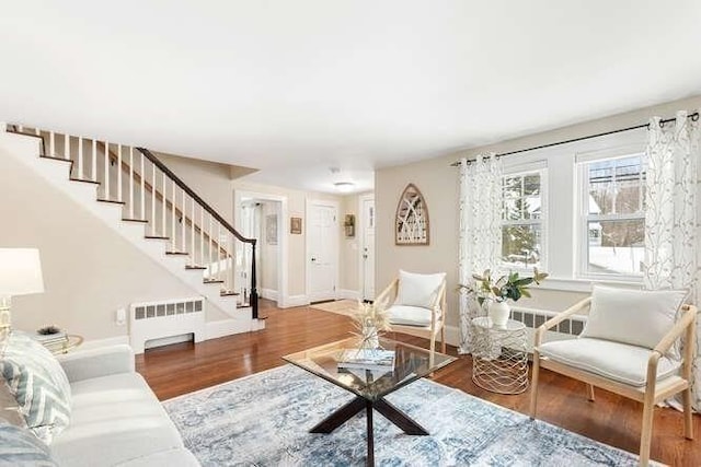 living room with wood-type flooring and radiator heating unit