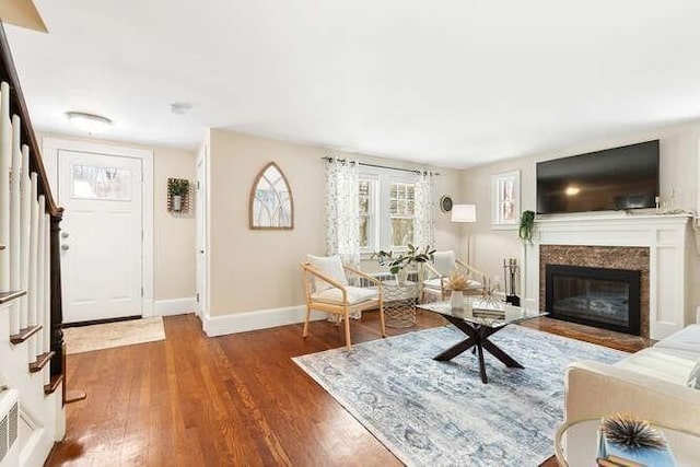 living room with dark hardwood / wood-style flooring