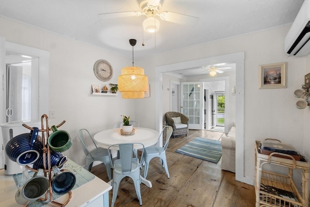 13 Hathaway St, Fairhaven, MA 02719 - dining space featuring a wall unit AC, light wood finished floors, a ceiling fan, and baseboards