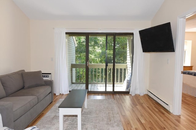 living room with a baseboard radiator, lofted ceiling, and light wood-type flooring