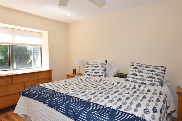 bedroom with ceiling fan and hardwood / wood-style floors