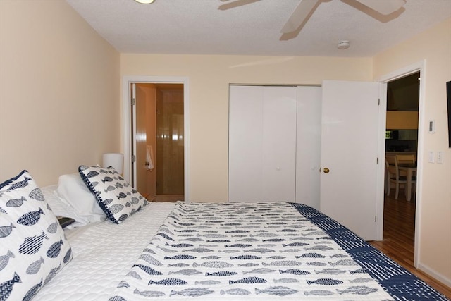 bedroom with hardwood / wood-style floors, a closet, and ceiling fan