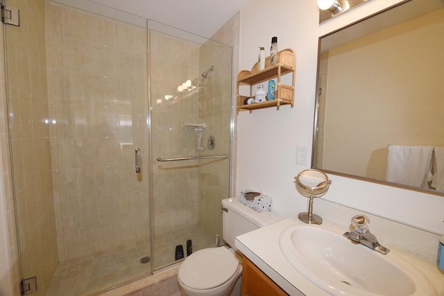 bathroom featuring vanity, toilet, and a shower with door