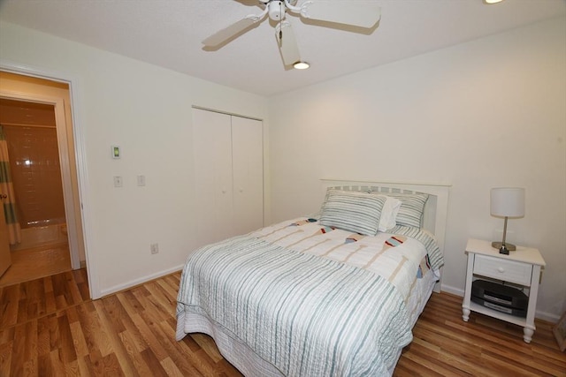 bedroom featuring hardwood / wood-style flooring, ceiling fan, and a closet