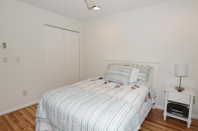 bedroom with hardwood / wood-style flooring and a closet