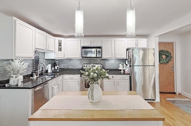 44 Lafayette Ave Unit 503, Chelsea, MA 02150 - kitchen with appliances with stainless steel finishes, a sink, white cabinetry, and backsplash