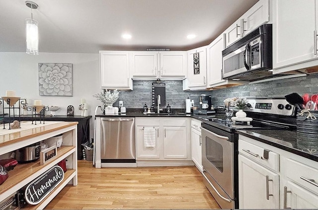 44 Lafayette Ave Unit 503, Chelsea, MA 02150 - kitchen featuring stainless steel appliances, a sink, white cabinets, tasteful backsplash, and recessed lighting