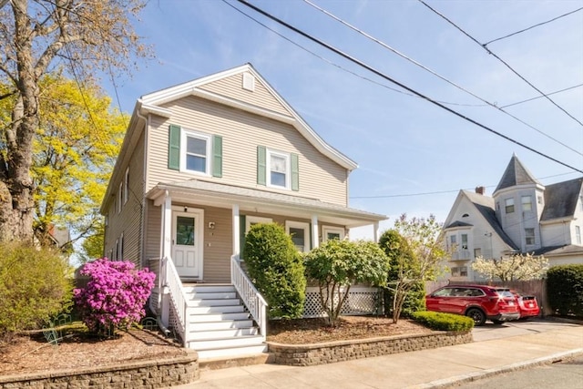 traditional style home featuring covered porch