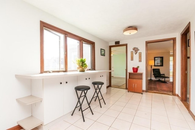 kitchen featuring baseboards and a breakfast bar area