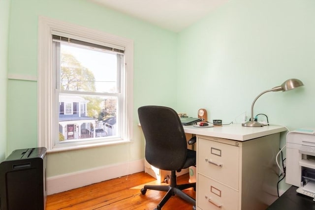 office area with light wood-type flooring and baseboards