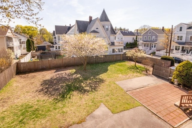 view of yard with a patio, a residential view, and a fenced backyard