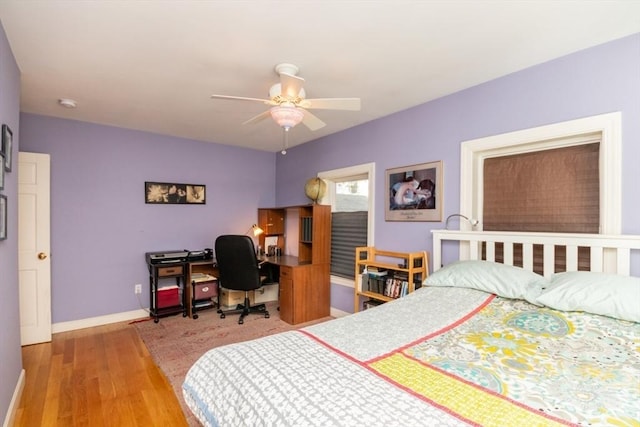 bedroom featuring light wood-style floors, baseboards, and ceiling fan