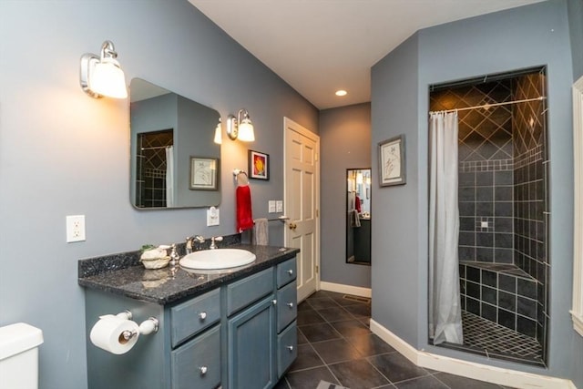 full bath featuring toilet, baseboards, a tile shower, and tile patterned flooring