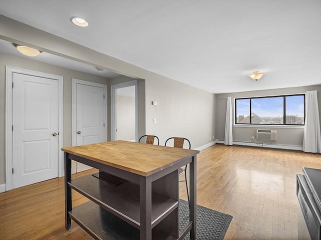 dining space featuring recessed lighting, baseboards, light wood-style floors, and a wall mounted AC