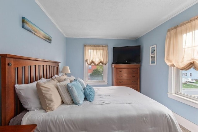 bedroom with a textured ceiling and ornamental molding