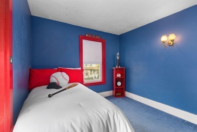 bedroom featuring baseboards and carpet