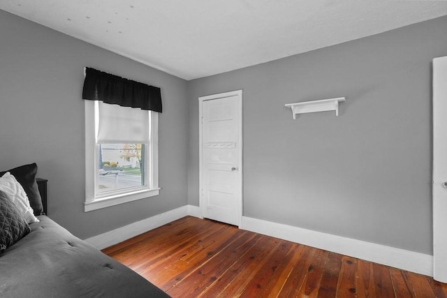 interior space featuring baseboards and dark wood-style flooring