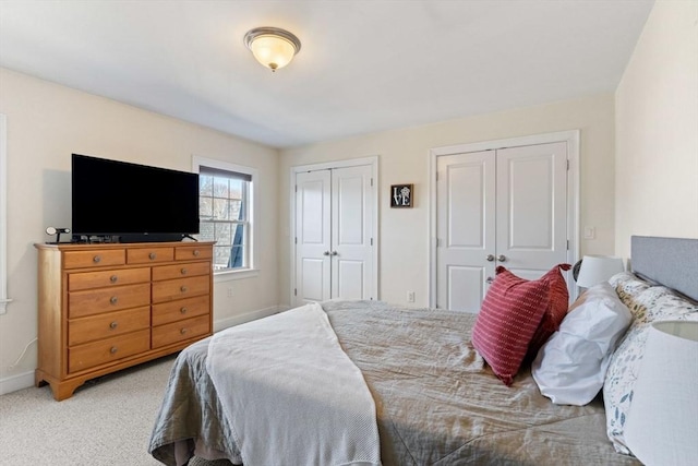 carpeted bedroom with two closets