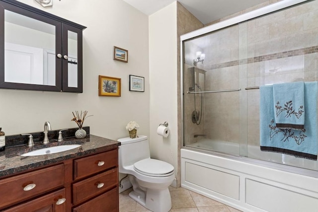 full bathroom with toilet, vanity, tile patterned flooring, and shower / bath combination with glass door