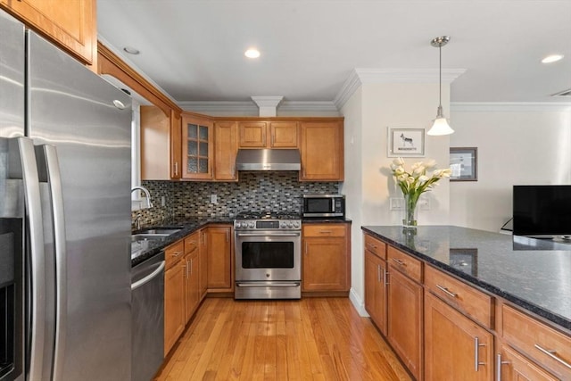 kitchen featuring appliances with stainless steel finishes, backsplash, decorative light fixtures, ornamental molding, and sink