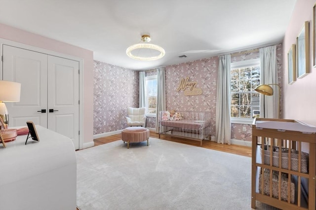 57 Chittenden Rd, Scituate, MA 02066 - bedroom with wallpapered walls, baseboards, wood finished floors, and a closet