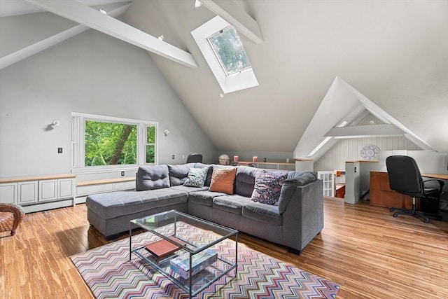 6 Fruit St, Hopkinton, MA 01748 - living area featuring a skylight, beam ceiling, wood finished floors, plenty of natural light, and high vaulted ceiling