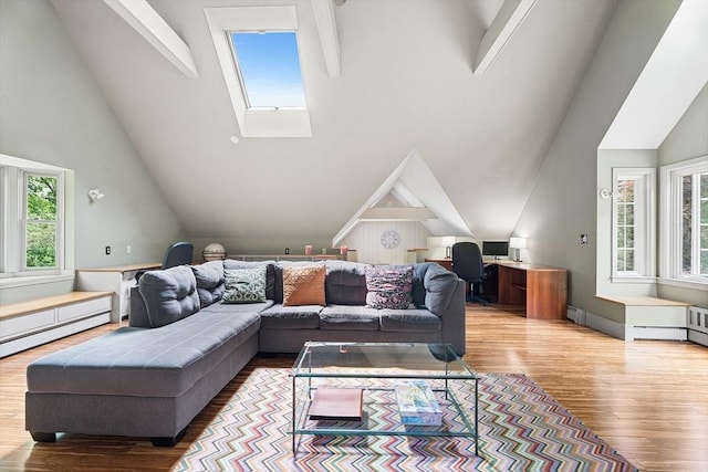 6 Fruit St, Hopkinton, MA 01748 - living room with plenty of natural light, wood finished floors, a skylight, high vaulted ceiling, and a baseboard heating unit