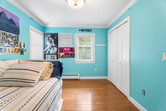 6 Fruit St, Hopkinton, MA 01748 - bedroom featuring baseboard heating, crown molding, wood finished floors, and a closet