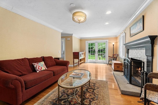 6 Fruit St, Hopkinton, MA 01748 - living room featuring ornamental molding, light wood-type flooring, a warm lit fireplace, recessed lighting, and french doors